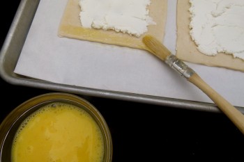 brush with egg wash on pastry squares with cheese