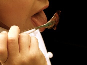 Girl eating jam with spoon