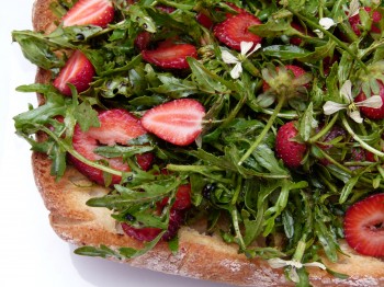 wild arugula and strawberry salad on a Ciabatta plank