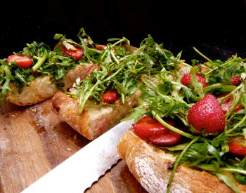 wild arugula and strawberry salad on a Ciabatta plank