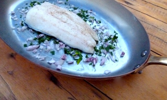 braising pan with butter , parsley,  shallots and cod fillet 