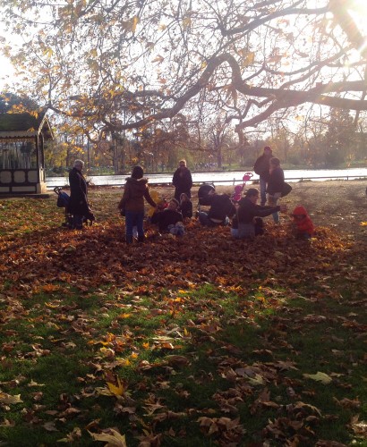 parisian family playing in golden leaves