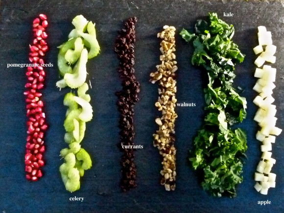 ingrediants for the updated Waldorf salad pomegranate seeds, celery, currants, walnuts, Kale