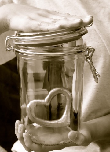 girl preserving doll in glass jar