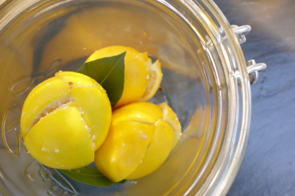 quartered and salted lemons in glass jar