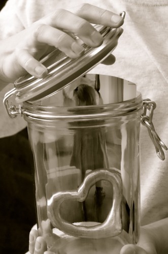 girl preserving doll in glass jar