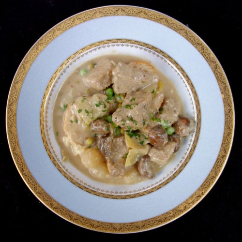  la blanquette de veau (veal stew in a white wine-crème fraîche sauce with mushrooms, pearl onions, and artichoke hearts served on garlic-rubbed toasted French bread