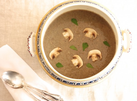 mushroom soup with truffled straws close up on soup with sliced mushrooms