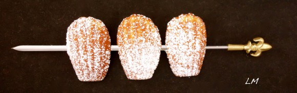 cupids bow with three powdered sugar dusted madeleines 