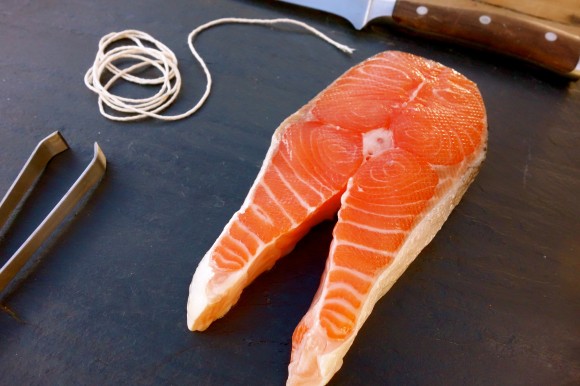 salmon on cutting board with knife